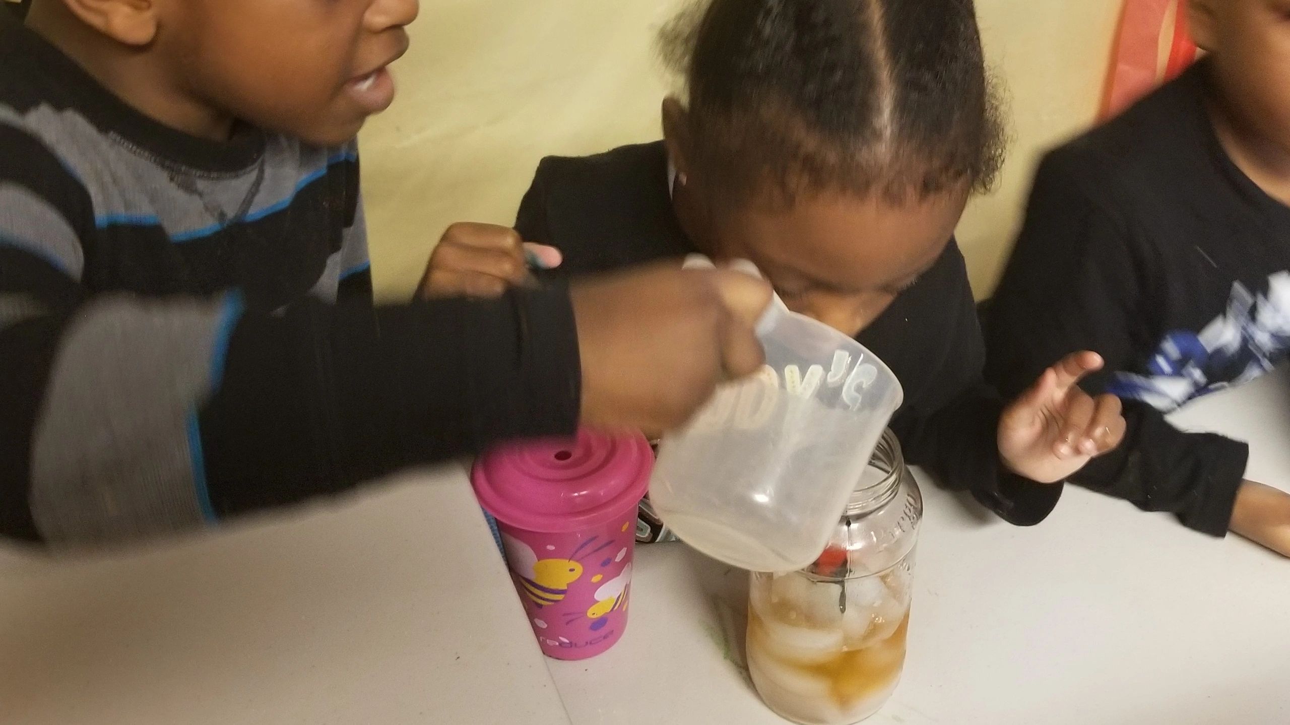 Children doing a science experiment at Home4Kidz