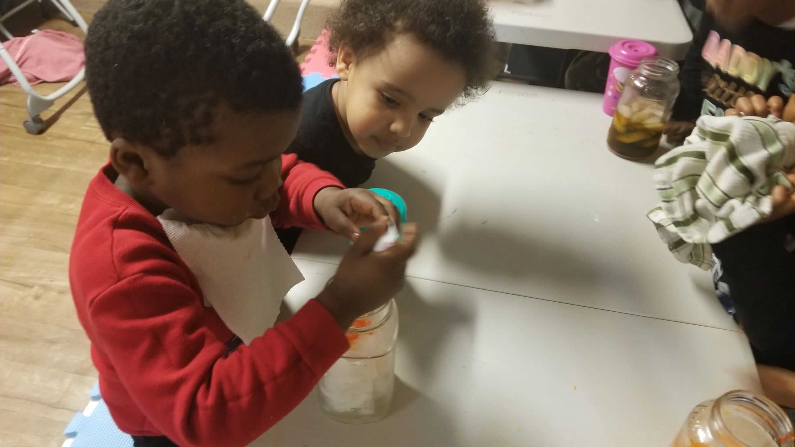 Two children working together on a craft at Home4Kidz